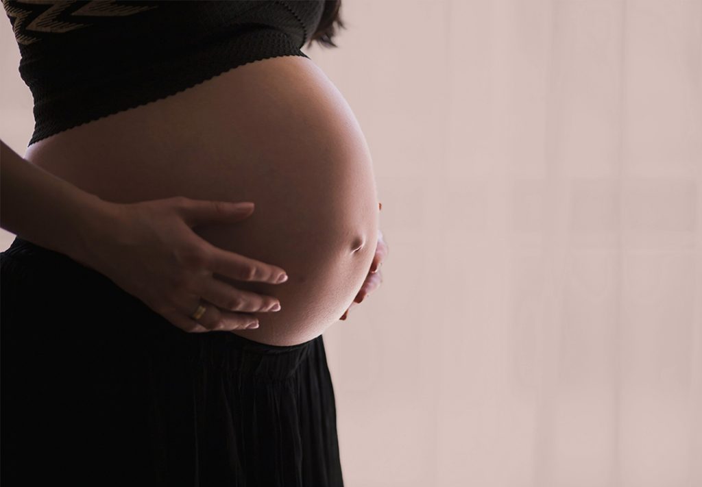 pregnant woman holding belly