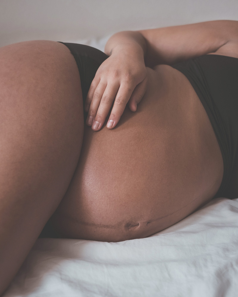 Pregnant person laid on bed